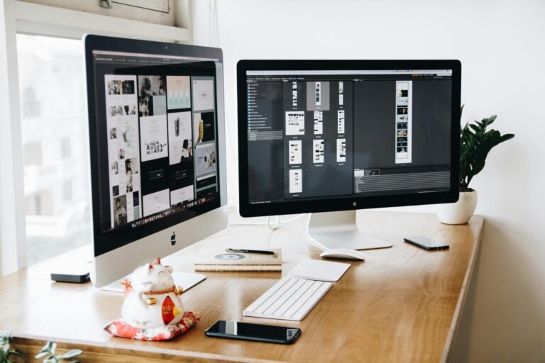 2 computer monitors with design items on them